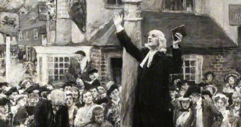 John Wesley preaching outdoors to a crowd