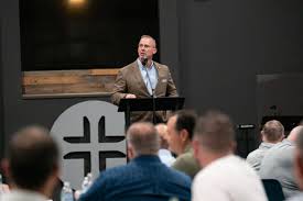 Clint Pressley speaking at a theological conference