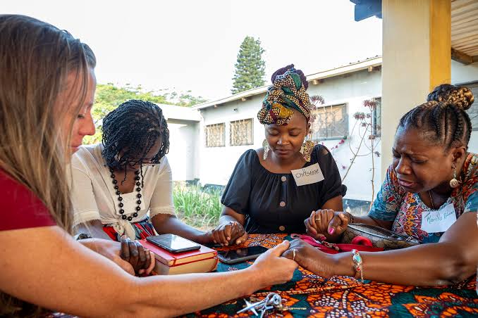 Southern Baptist missionaries praying with local believers overseas