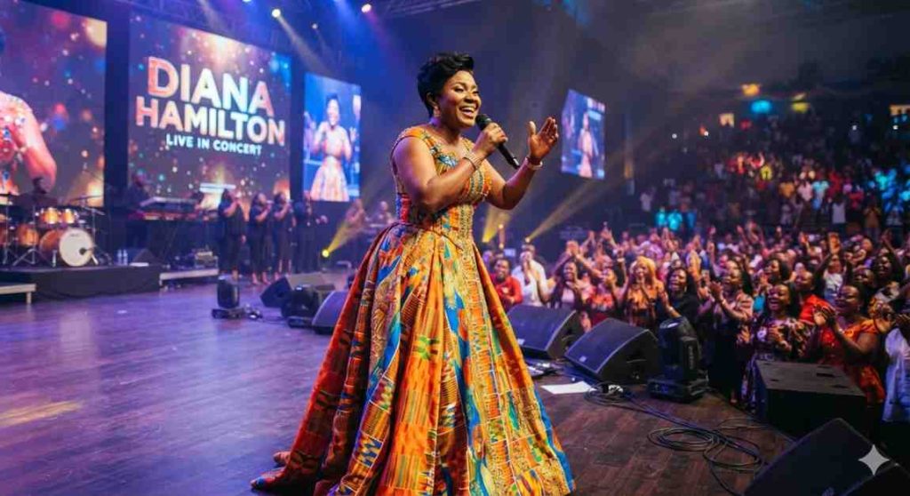 Diana Hamilton performing on stage in a colorful gown