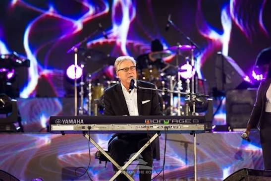 Don Moen leading worship on stage with a piano