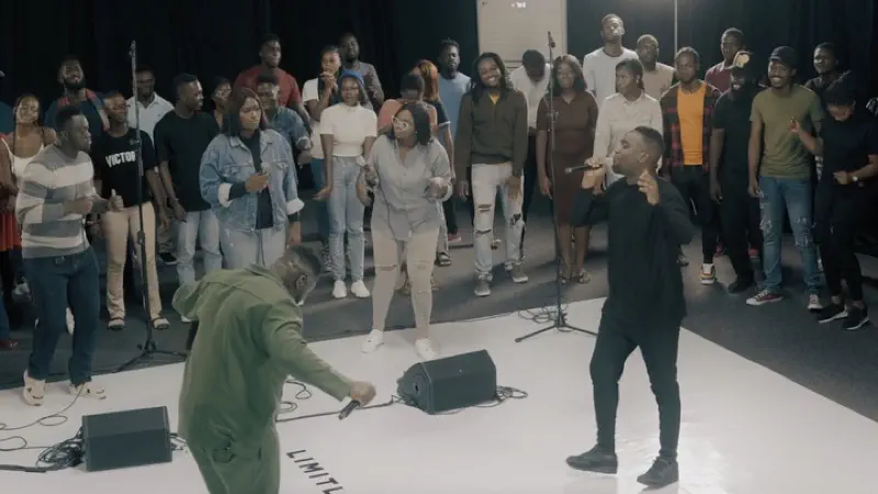 Ryan Ofei performing live on stage with a worship team